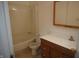 Standard bathroom featuring a shower-tub combo, toilet, and wood-look vanity at 3612 Carolee Ct, Indianapolis, IN 46227