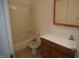 Standard bathroom featuring a shower-tub combo, toilet, and wood-look vanity at 3612 Carolee Ct, Indianapolis, IN 46227