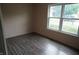 Bedroom with neutral walls and laminate flooring, featuring a large window for natural light at 3612 Carolee Ct, Indianapolis, IN 46227