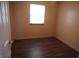 Cozy bedroom features updated flooring and a window for natural light at 3612 Carolee Ct, Indianapolis, IN 46227