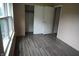 Bedroom showcasing laminate flooring, sliding closet doors, and a well-lit interior at 3612 Carolee Ct, Indianapolis, IN 46227