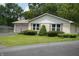 Well-kept single-story home with brick siding, manicured landscaping, and a two-car garage at 3612 Carolee Ct, Indianapolis, IN 46227