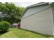 Close-up of the home's exterior highlighting the brick detail, siding, and lush green lawn at 3612 Carolee Ct, Indianapolis, IN 46227