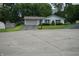 A single story home with a driveway and well maintained lawn and landscaping at 3612 Carolee Ct, Indianapolis, IN 46227