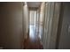 Hallway with hardwood floors and louvered closet doors provides access to multiple rooms at 3612 Carolee Ct, Indianapolis, IN 46227
