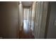 Hallway featuring wood-look floors, white doors and neutral walls at 3612 Carolee Ct, Indianapolis, IN 46227