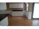 The kitchen area features wood laminate floors, white cabinets, and a window with natural light at 3612 Carolee Ct, Indianapolis, IN 46227