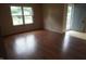 Entry into living room featuring wood-look flooring, a bright window, and open door at 3612 Carolee Ct, Indianapolis, IN 46227