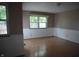 A naturally lit living room with wood laminate flooring and white wainscoting at 3612 Carolee Ct, Indianapolis, IN 46227