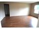 Bright living room with wood-look flooring and neutral wall paint at 3612 Carolee Ct, Indianapolis, IN 46227