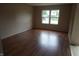 Inviting living room features hardwood-style flooring and a bright window at 3612 Carolee Ct, Indianapolis, IN 46227