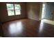 Bright living room featuring wood-look flooring and a large window overlooking the front yard at 3612 Carolee Ct, Indianapolis, IN 46227