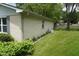 Well-maintained backyard featuring a lush green lawn, mature shrubs, and white brick at 3612 Carolee Ct, Indianapolis, IN 46227