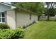 Well-maintained backyard featuring a lush green lawn, mature shrubs, and white brick at 3612 Carolee Ct, Indianapolis, IN 46227