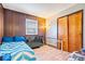 Bedroom boasts paneled walls, wood-look floors, a storage closet, and a bed for a comfortable living space at 3801 N Vernon Dr, Muncie, IN 47304