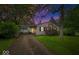 Single-story home with driveway and carport nestled on a well-maintained lawn with mature landscaping at 3801 N Vernon Dr, Muncie, IN 47304