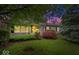Charming single-story home featuring a lush front yard with mature trees and colorful landscaping at 3801 N Vernon Dr, Muncie, IN 47304
