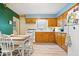 Bright kitchen with oak cabinets, adjacent dining area, and natural light at 3801 N Vernon Dr, Muncie, IN 47304