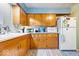 Spacious kitchen showcasing oak cabinets and a refrigerator at 3801 N Vernon Dr, Muncie, IN 47304