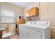 The laundry room offers a washer, dryer, cabinets, and a window to make laundry chores more convenient at 3801 N Vernon Dr, Muncie, IN 47304