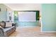 Inviting living room with projector screen and light-filled window at 3801 N Vernon Dr, Muncie, IN 47304