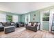 Bright living room featuring two couches, and large windows providing an abundance of natural light at 3801 N Vernon Dr, Muncie, IN 47304