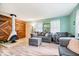Living room featuring a white fireplace, a wood accent wall, two couches, and large windows at 3801 N Vernon Dr, Muncie, IN 47304