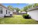 A view of the property's spacious and grassy backyard with a detached garage at 4244 Asbury St, Indianapolis, IN 46227