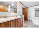 Bathroom with double sinks, vanity, and combined shower and tub at 4244 Asbury St, Indianapolis, IN 46227