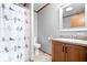 Bathroom features a vanity with a single sink, a toilet, and a tub with a decorative shower curtain at 4244 Asbury St, Indianapolis, IN 46227