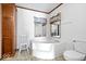 Relaxing bathroom with a large soaking tub, toilet and a built-in closet at 4244 Asbury St, Indianapolis, IN 46227
