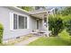Cozy front porch featuring neutral siding, a charming wind chime, and well-maintained landscaping at 4244 Asbury St, Indianapolis, IN 46227