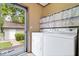 View of the laundry room complete with a washer and dryer along with an exterior view of the property at 4244 Asbury St, Indianapolis, IN 46227