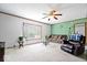 Bright living room with large windows, plush carpeting, and comfortable seating, perfect for relaxing or entertaining at 4244 Asbury St, Indianapolis, IN 46227