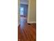 Bedroom showing original hardwood floors transitioning through an open doorway at 427 N Alton Ave, Indianapolis, IN 46222