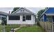 Charming home featuring white paint, a small front porch, and a fenced yard, ideal for first-time buyers at 427 N Alton Ave, Indianapolis, IN 46222