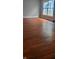 Spacious living area with hardwood floors and a bright window, offering a versatile space for relaxation and entertainment at 427 N Alton Ave, Indianapolis, IN 46222
