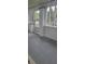 Covered front porch with a painted floor, white brick columns, and paneled windows, perfect for enjoying outdoor views at 427 N Alton Ave, Indianapolis, IN 46222