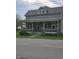 Charming two-story home featuring a welcoming front porch with stone pillars and a landscaped yard at 4303 W County Road 200 S Rd, Danville, IN 46122
