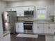 Bright kitchen with stainless steel appliances, white cabinets, and granite countertops at 4303 W County Road 200 S Rd, Danville, IN 46122