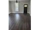 Spacious living room with dark wood floors, a window with sheer curtains, and a stylish dark-stained front door at 4303 W County Road 200 S Rd, Danville, IN 46122