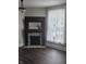 Cozy living room showcasing a dark wood fireplace with decorative tiles and a large window at 4303 W County Road 200 S Rd, Danville, IN 46122