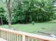 View from the wooden deck, with lush green lawn and trees surrounding the property at 4675 N Herbemont Rd, Martinsville, IN 46151