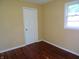 Bright bedroom featuring hardwood floors, a closet, and a window offering natural light at 4675 N Herbemont Rd, Martinsville, IN 46151