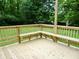 Wooden deck featuring built-in bench seating and green lawn at 4675 N Herbemont Rd, Martinsville, IN 46151