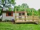 Exterior rear view of home with wood siding, updated deck, and mature trees at 4675 N Herbemont Rd, Martinsville, IN 46151