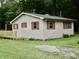 This image displays the exterior of a single Gathering home with a small deck and green grass at 4675 N Herbemont Rd, Martinsville, IN 46151
