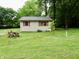 Charming house surrounded by a green yard, featuring wood siding and inviting curb appeal at 4675 N Herbemont Rd, Martinsville, IN 46151