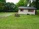 Home exterior featuring wood siding and trim in wooded backyard setting at 4675 N Herbemont Rd, Martinsville, IN 46151