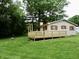 This image displays the side of a single Gathering home with wood siding and a wood deck at 4675 N Herbemont Rd, Martinsville, IN 46151